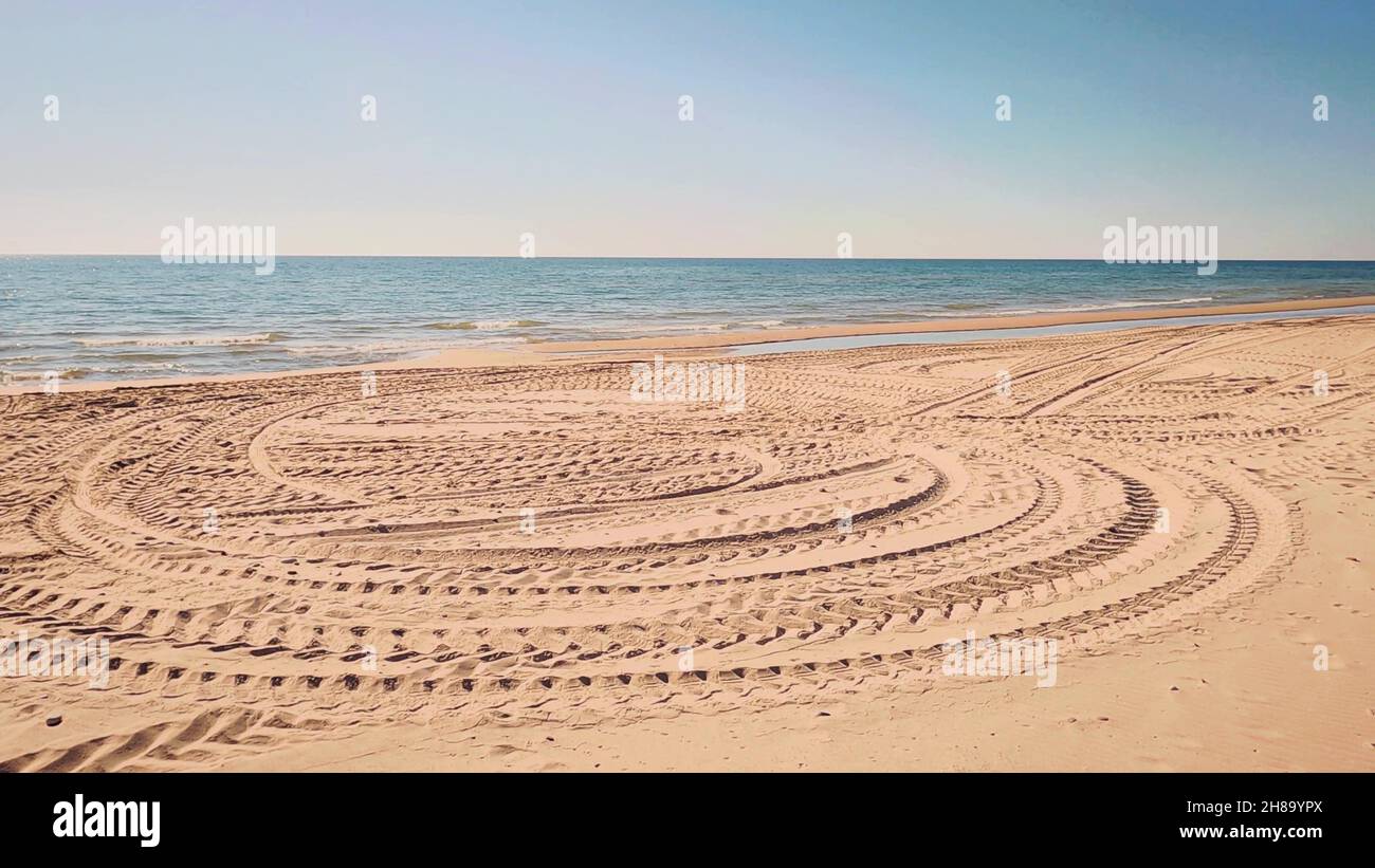 Tire tracks on the beach Stock Photo