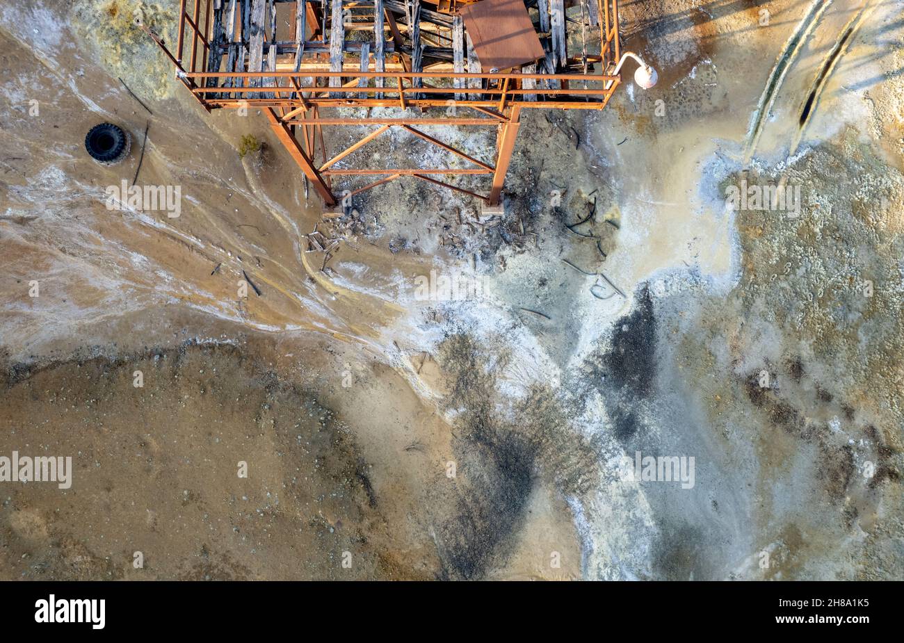 Aerial drone view of abandoned copper mine rusty structure with red