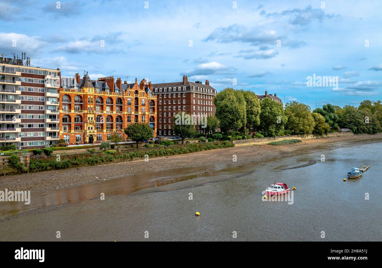 The Harlingham Court (Victorian mansion blocks) next to modern buildings, facing the river Thames in Fulham, London, England. Stock Photo
