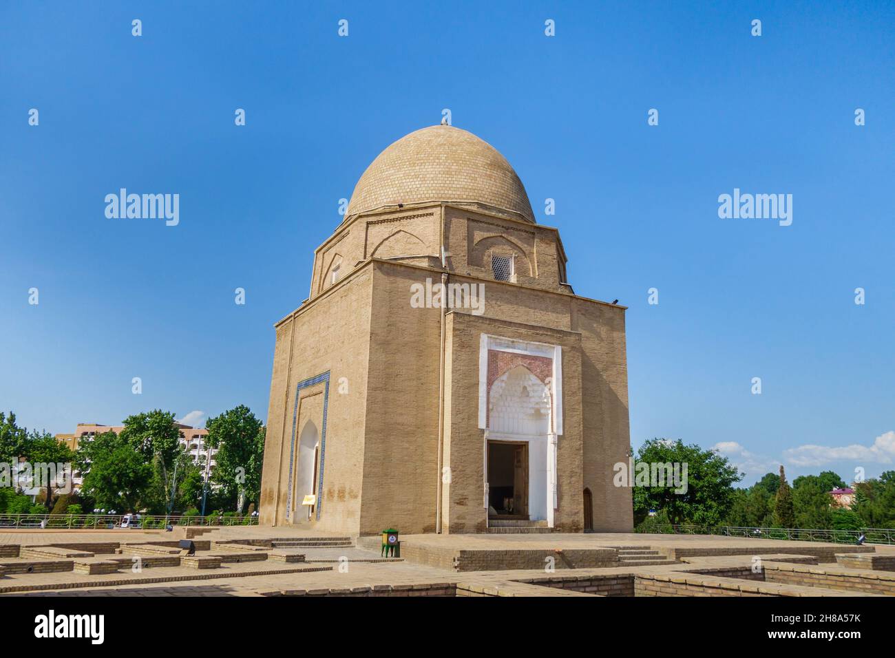 Panorama of Rukhabad mausoleum in Samarkand, Uzbekistan. Building was built in 1380. Foundations of ancient buildings are visible around. Writing on g Stock Photo