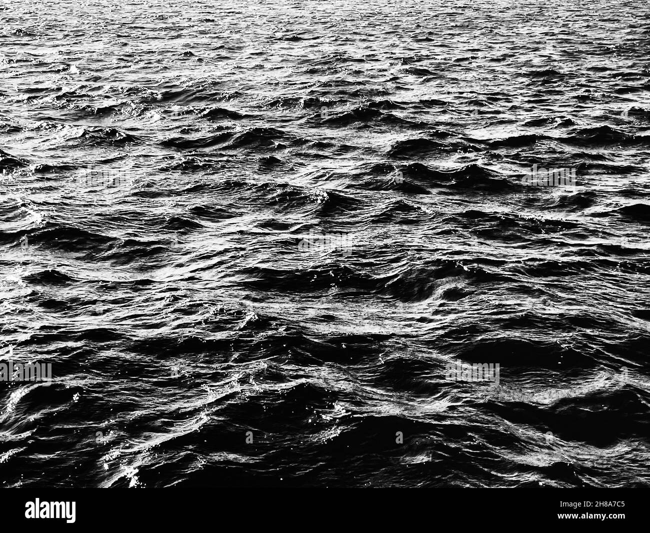 Sea, texture and coastal nature concept. Ocean water as black and white ...
