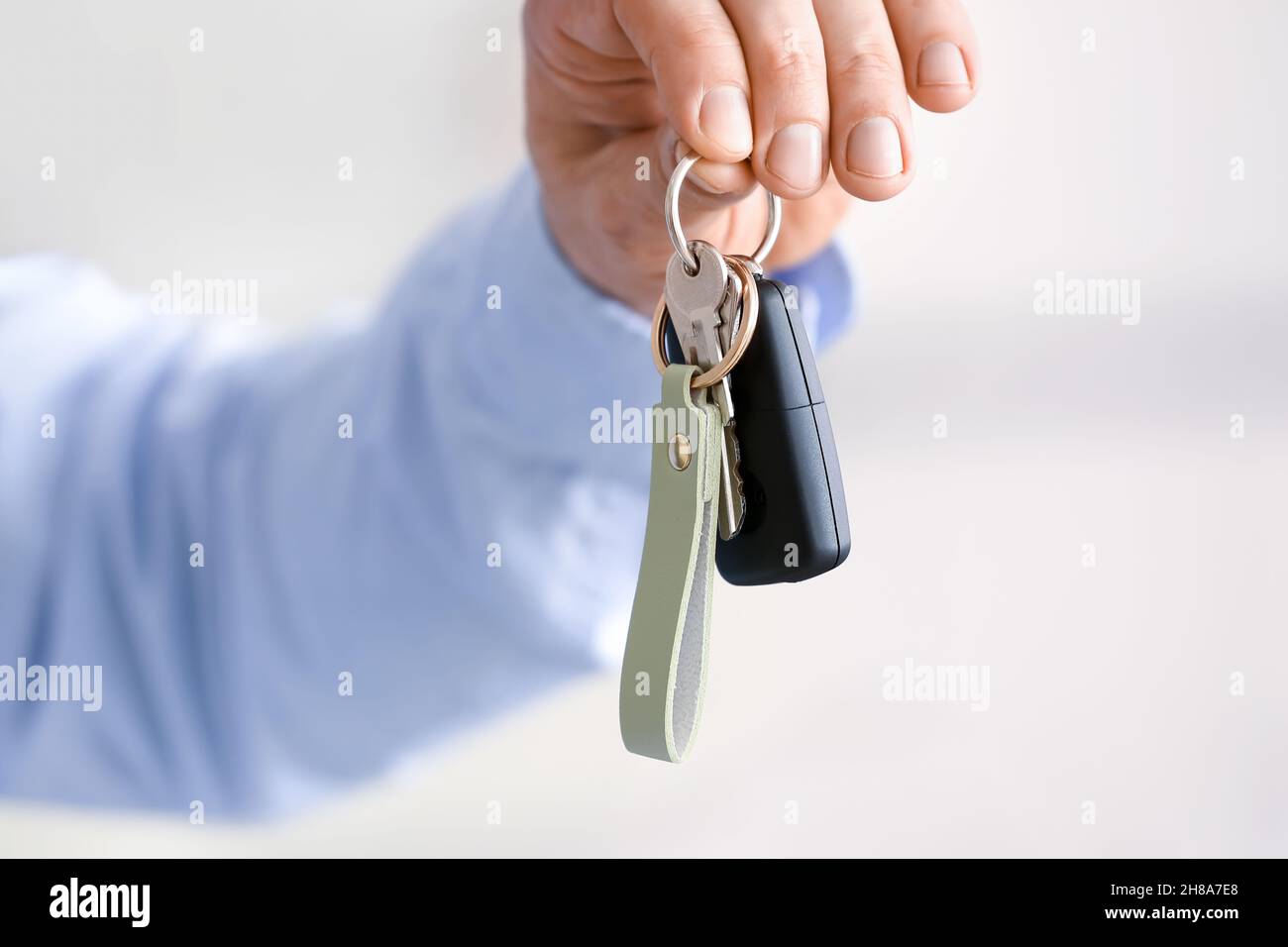Male hand holding keys on chain Stock Photo - Alamy