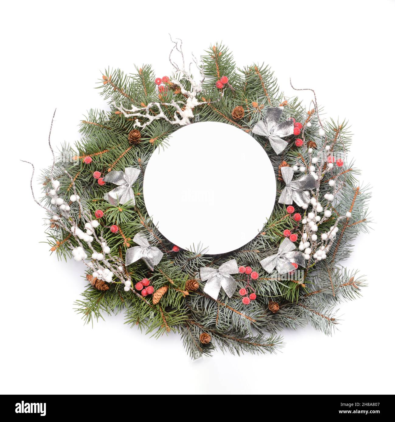 Beautiful Christmas wreath made of fir branches with blank card on ...