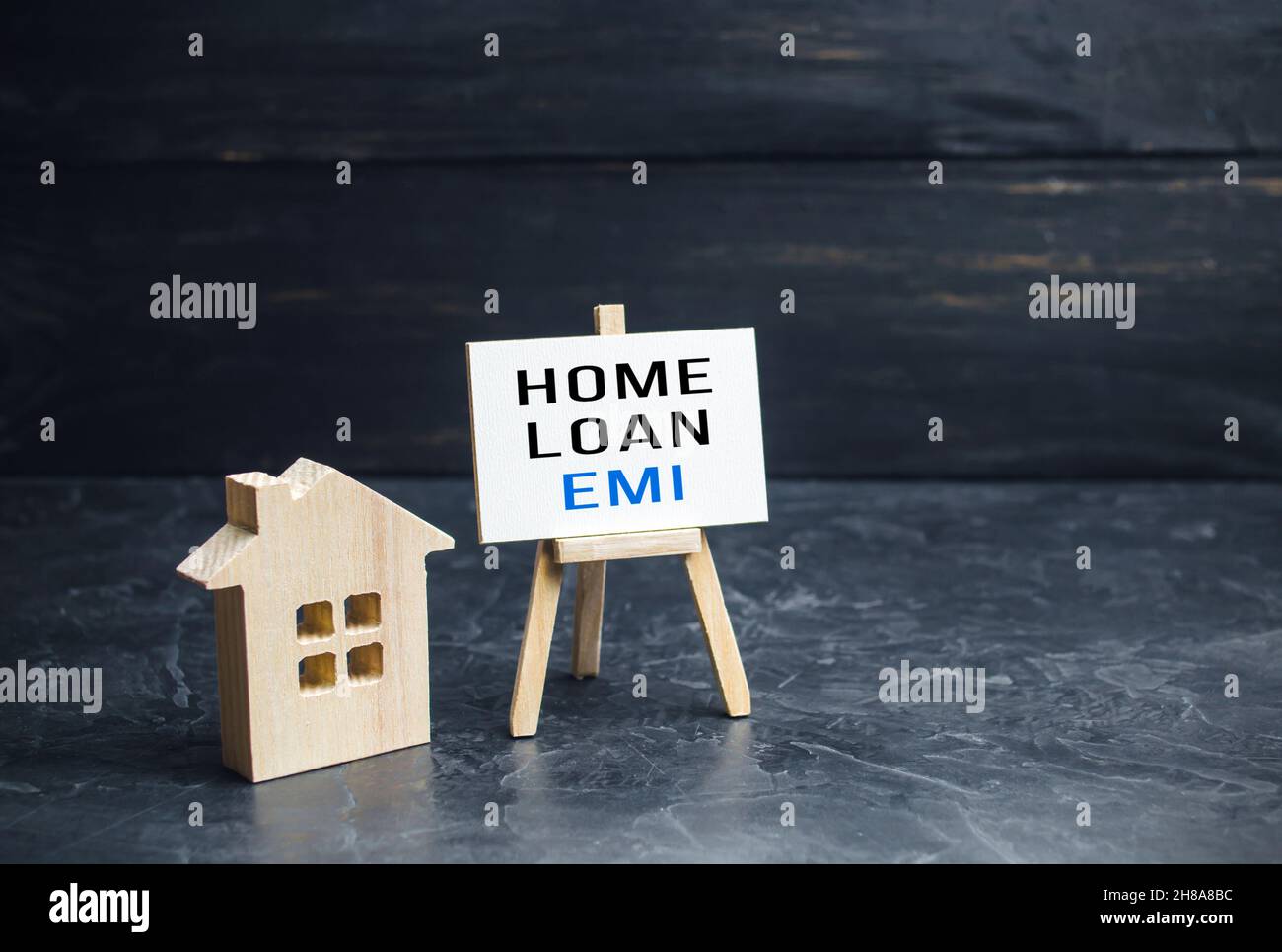 House with home loan EMI easel. Equated Monthly Installment loan. Reducing debt with regular payments over loans period. Attractive interest rates, cu Stock Photo