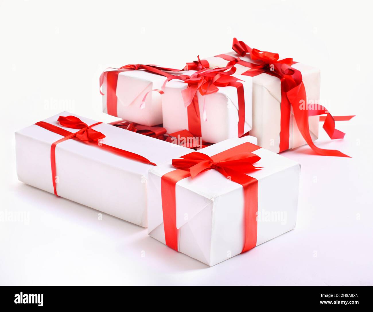 stack of red gift boxes decorated with bow isolated on white Stock ...