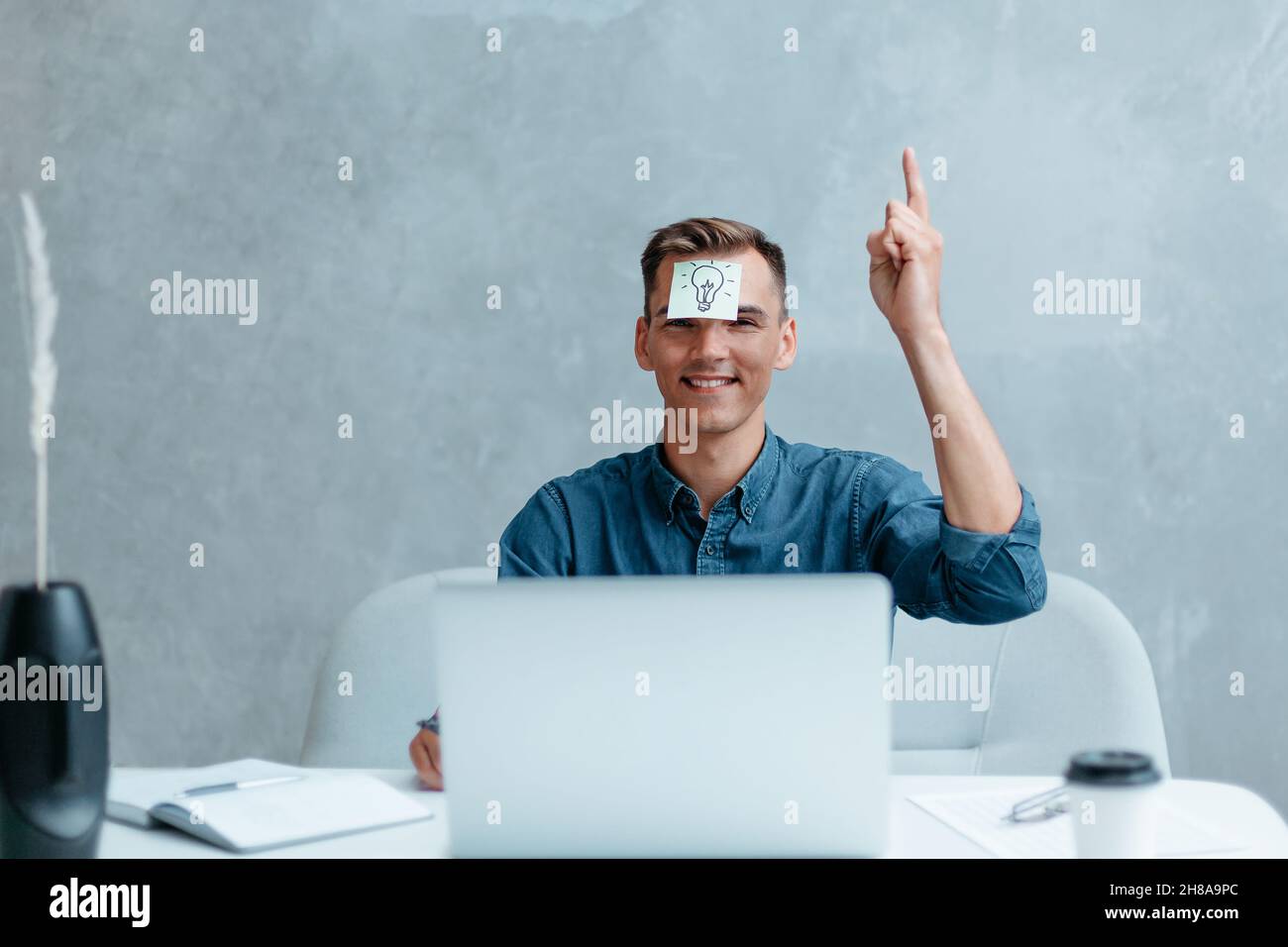 Satisfied man with raised hand thinking about good creative idea. Stock Photo