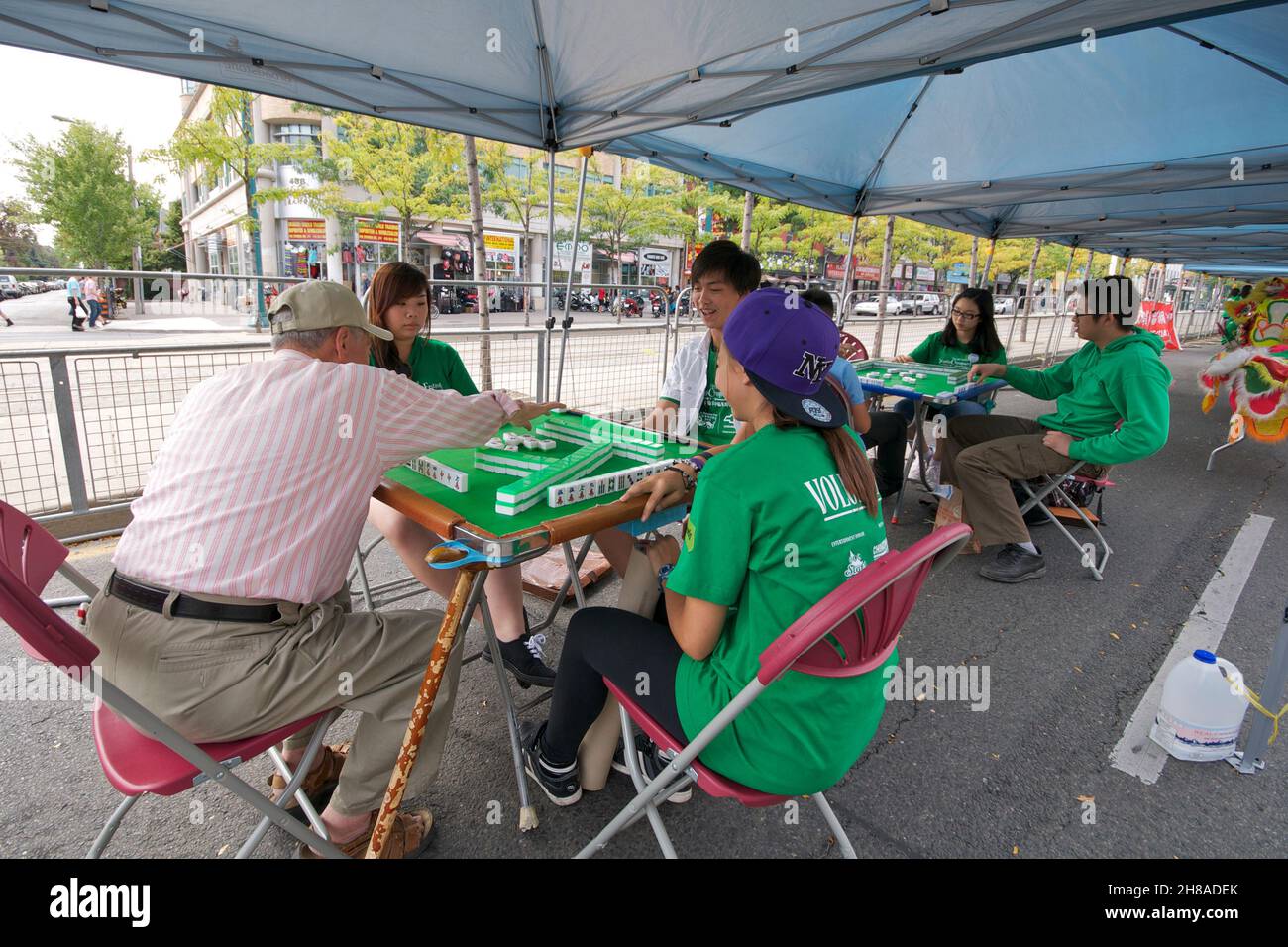 Toronto, Canada - Auguest,25, 2013: People playing Mahjong board game on a table in Chinatown, Toronto, Canada. Stock Photo