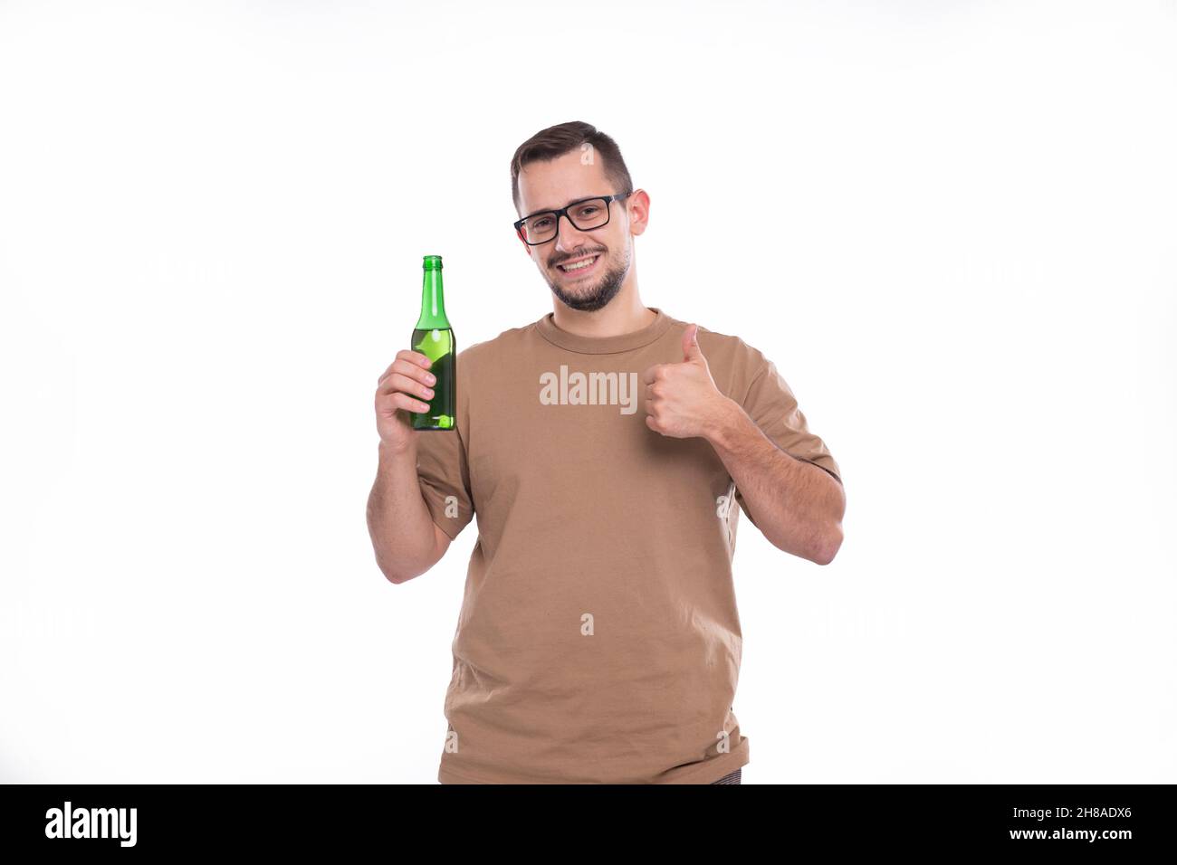 Man Holding Beer Bottle Showing Thumb Up. Man With Beer Bottle in Hands. Alcohol Drink Stock Photo
