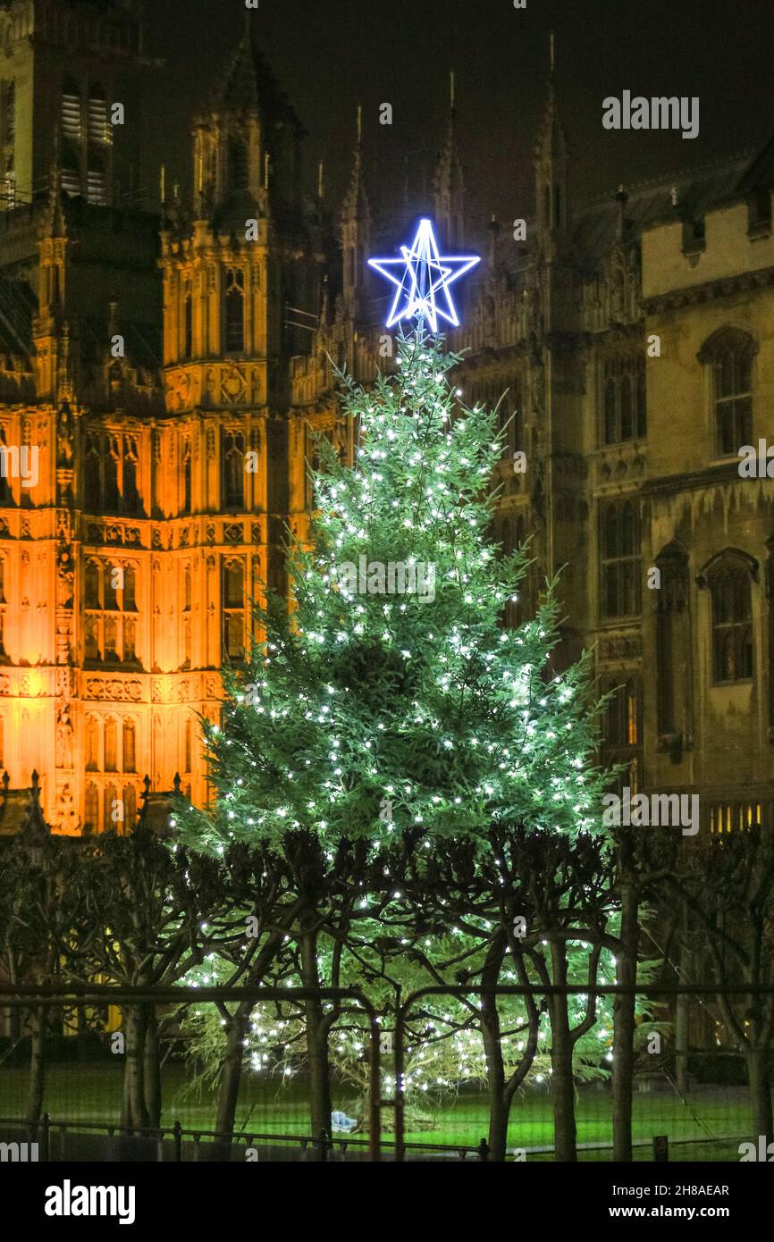 London, UK. 28th Nov, 2021. A tall Sitka spruce Christmas tree has been put up and illuminated in New Palace Yard, outside the Houses of Parliament in Westminster, as is the tradition every year, marking the beginning of the festive season at the Palace of Westminster. Credit: Imageplotter/Alamy Live News Stock Photo