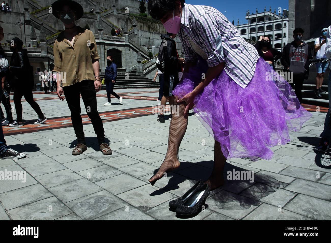 A trans chia prepares for the protest by putting on stockings and a dress.  Quito, November 28, 2021. Colectives Trans de Ecuador and the LGBTIQ  movement held a protest inside the church