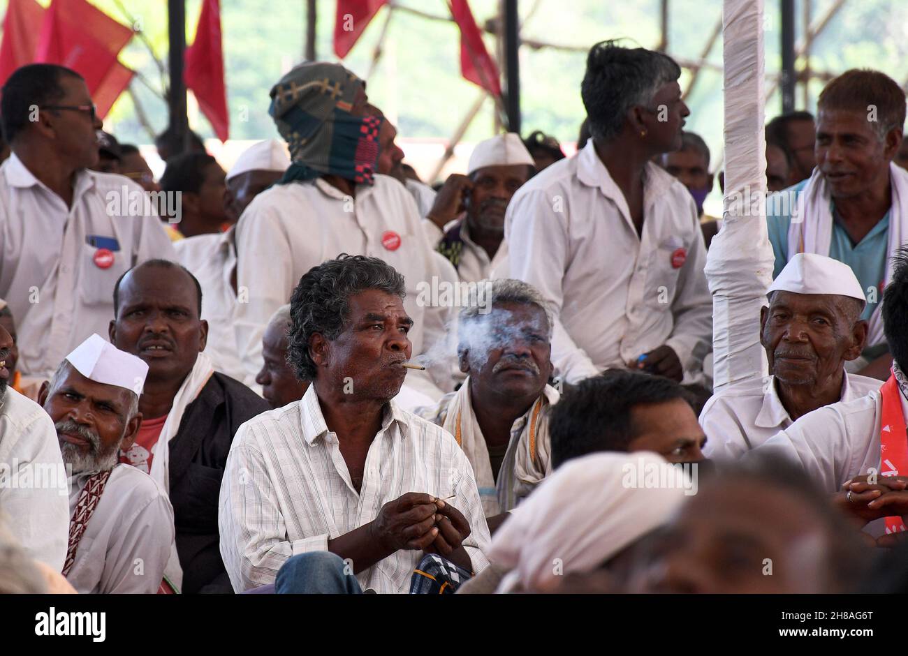 Mumbai, India. 28th Nov, 2021. A man is seen smoking during a sit down rally organised at Azad