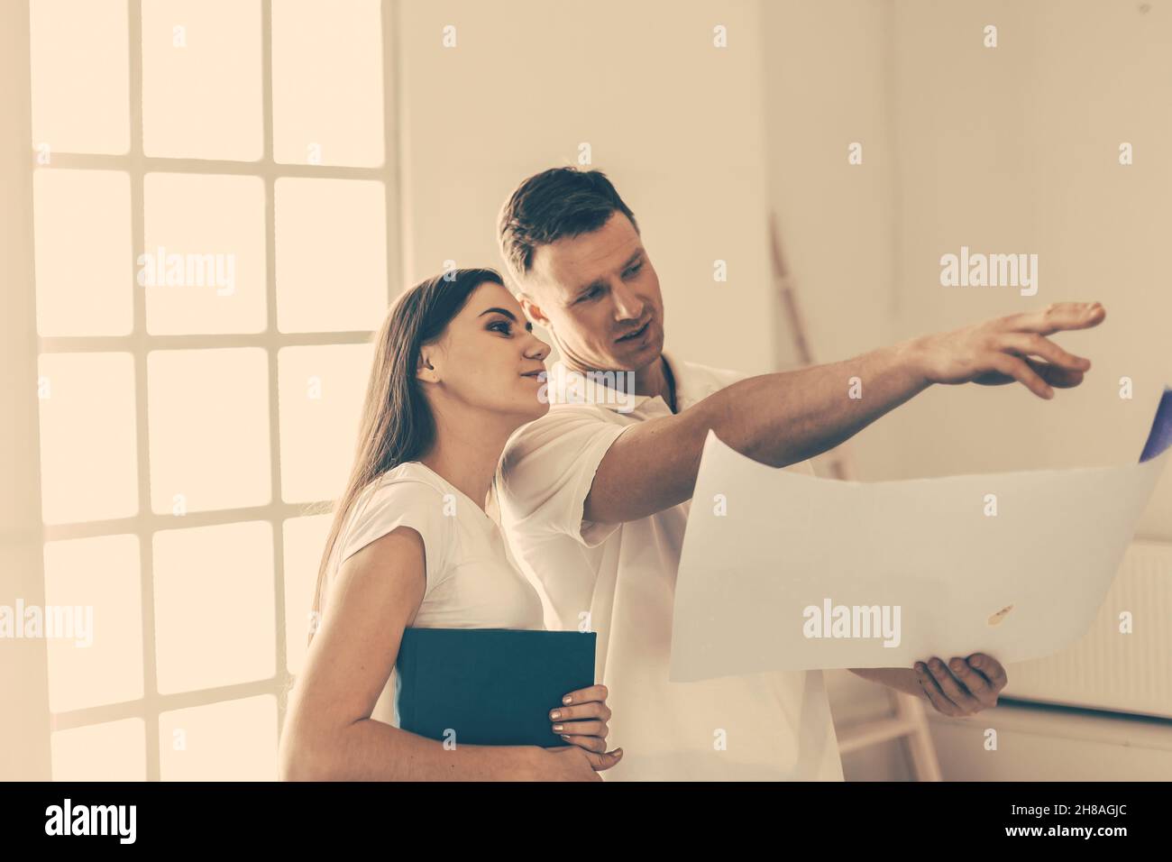 close up. young woman and a designer discussing the design of her new apartment. Stock Photo