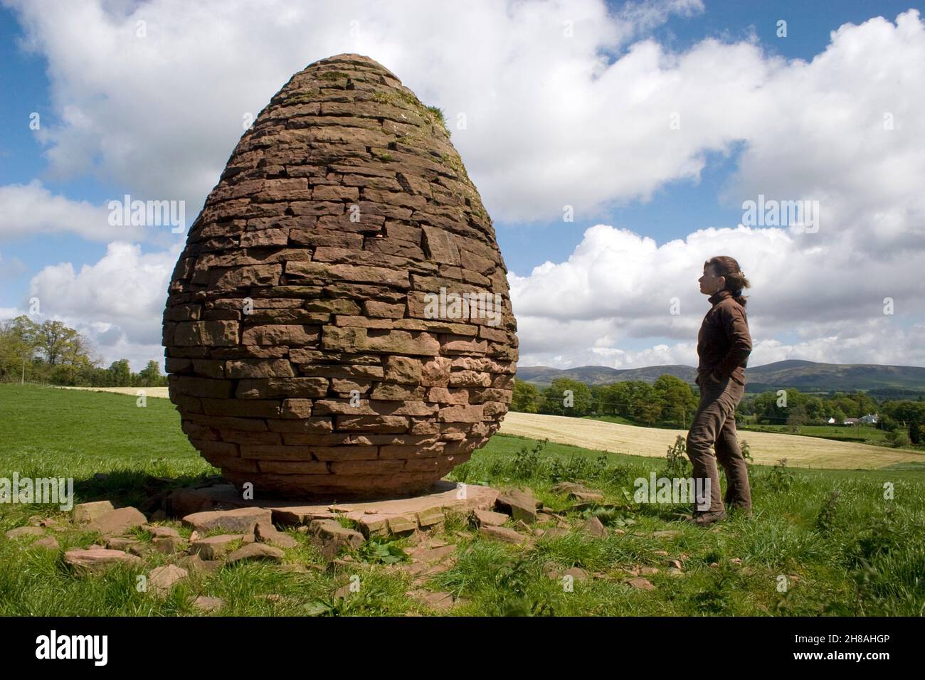 woman looking at stone sculpture by Andy Goldsworthy,  Burnhead, Penpont, nr Thornhill, Dumfries & Galloway, Scotland Stock Photo