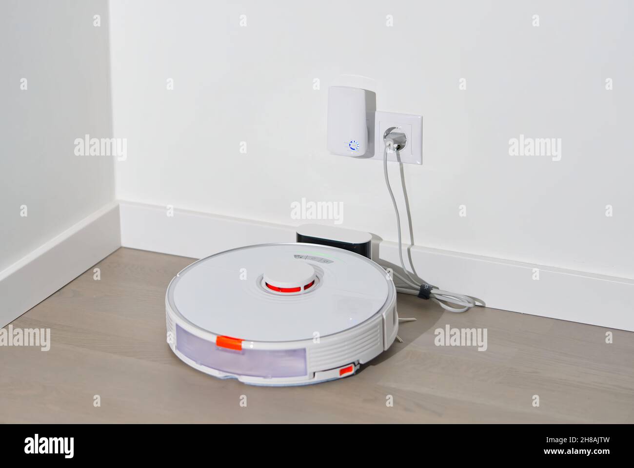 robot vacuum cleaner on charging dock station Stock Photo Alamy