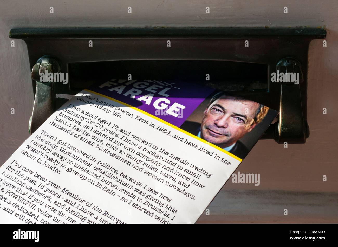A Nigel Farage election leaflet poking through a letter box. Stock Photo