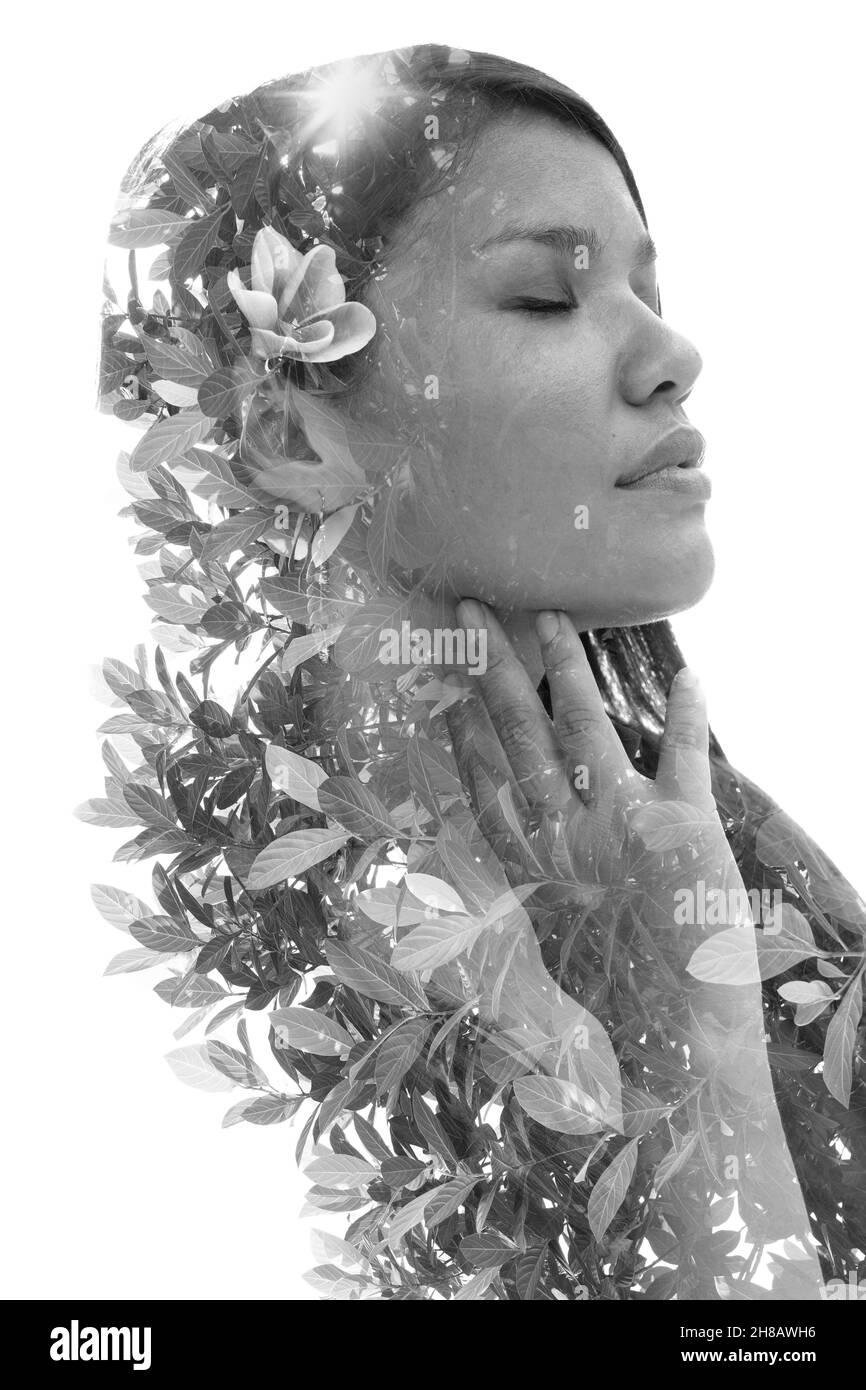A black and white portrait of a woman with a flower in her hair ...