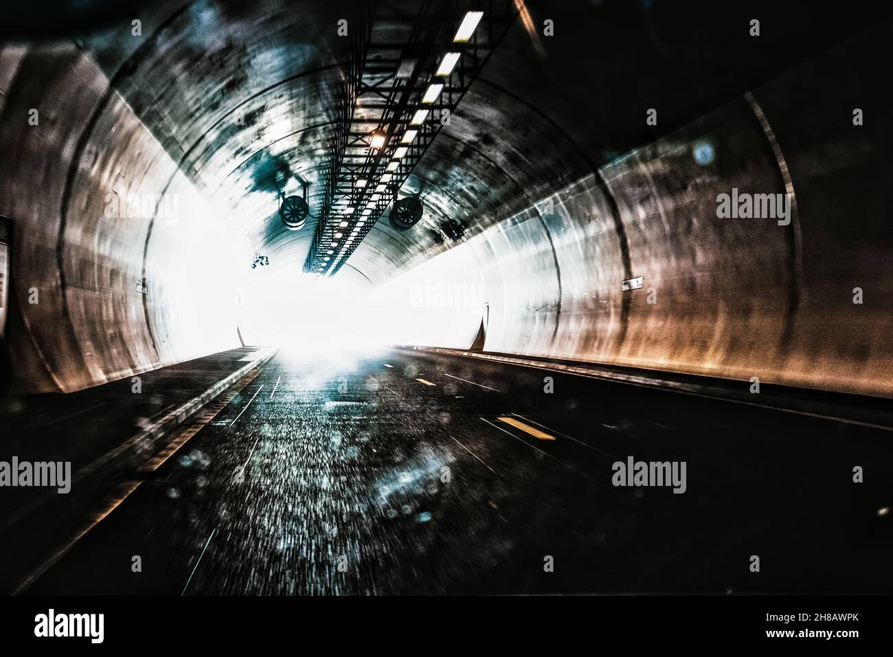 Speeding through a underground tunnel on the motorway towards the light Stock Photo