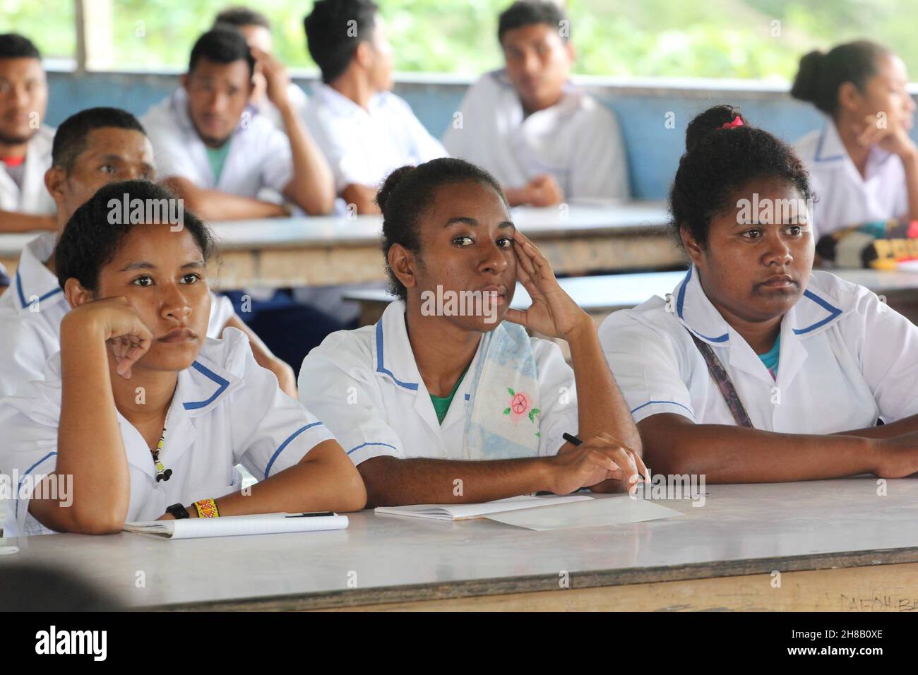 Female students at Kupuiano Secondary School in Central Province, Papua New Guinea listing to a presentation in 2018. Stock Photo