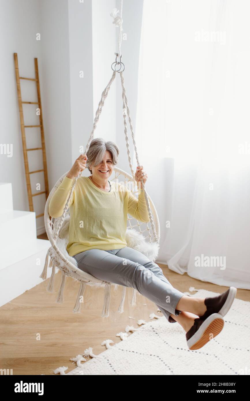 Woman sitting chair white pants hi-res stock photography and images - Alamy