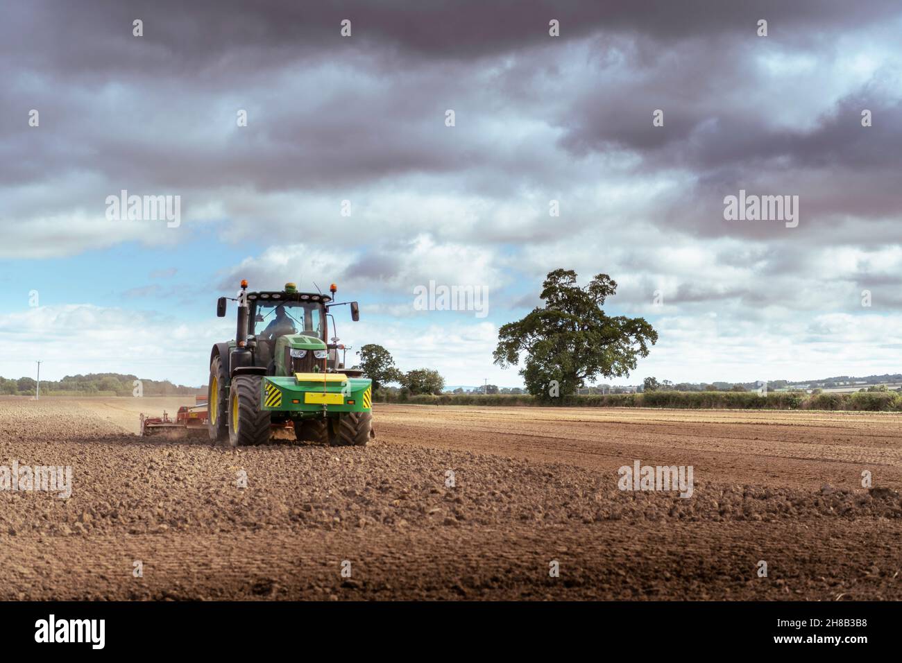 Tractor in plowed field Stock Photo