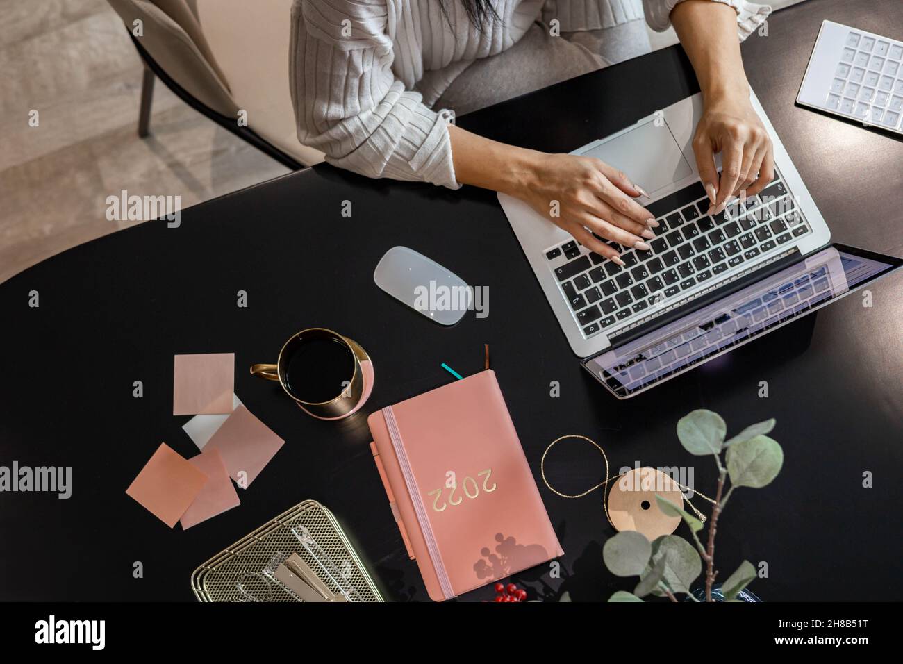 Top view woman hands typing keyboard of laptop working online browsing internet or chatting Stock Photo