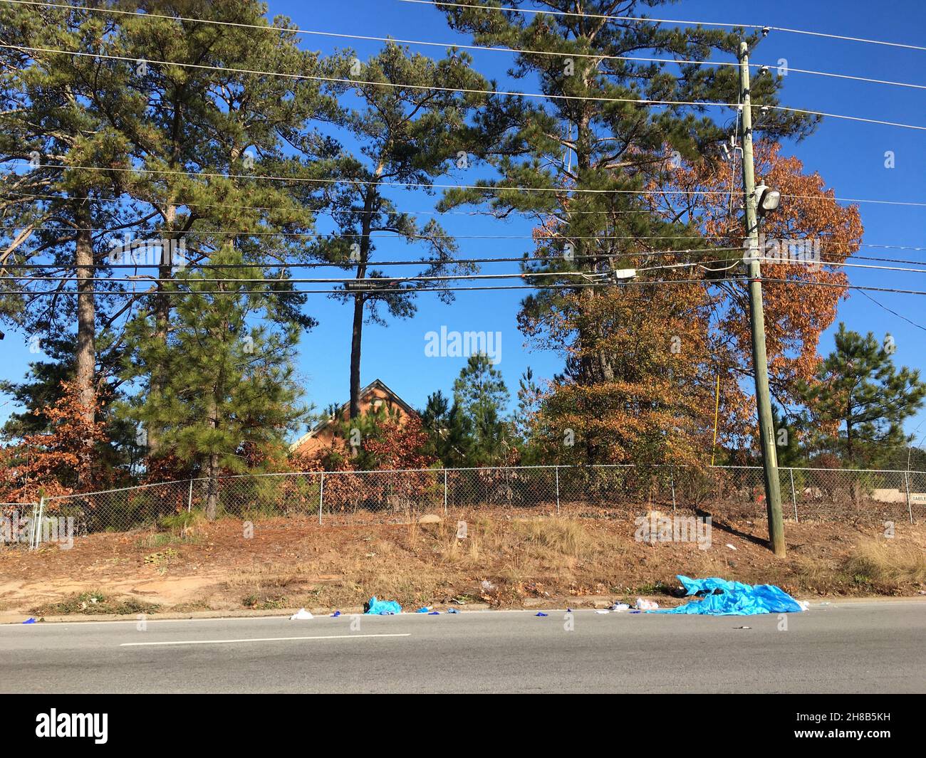 A ragged tarp discarded at roadside Stock Photo