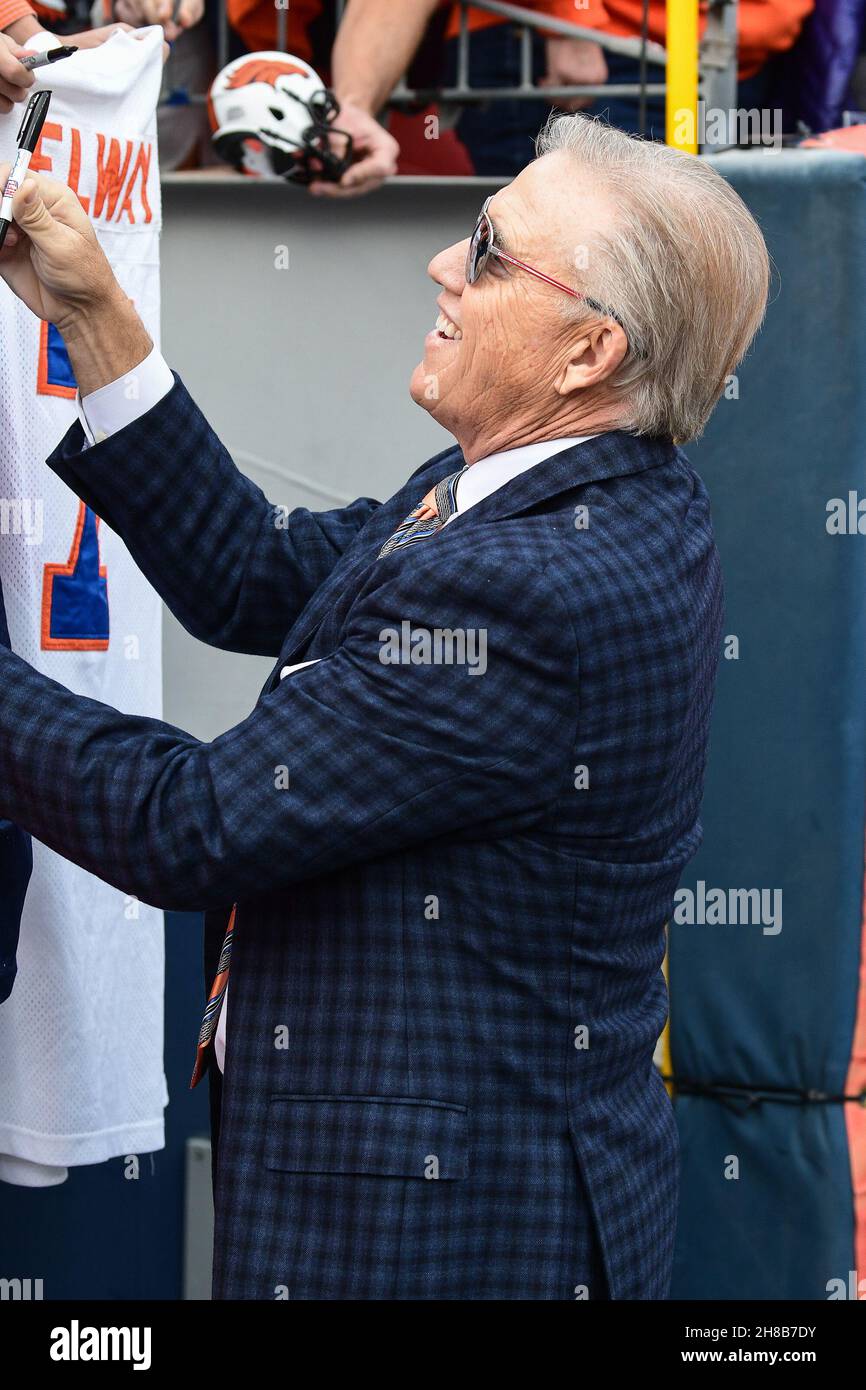 Denver, CO, USA. 28th Nov, 2021. Denver Broncos President of Football Operations and Hall of Fame quarterback Joh Elway signs an autograph before the football game between the Denver Broncos and Los Angeles Chargers at Empower Field Field in Denver, CO. Derek Regensburger/CSM/Alamy Live News Stock Photo