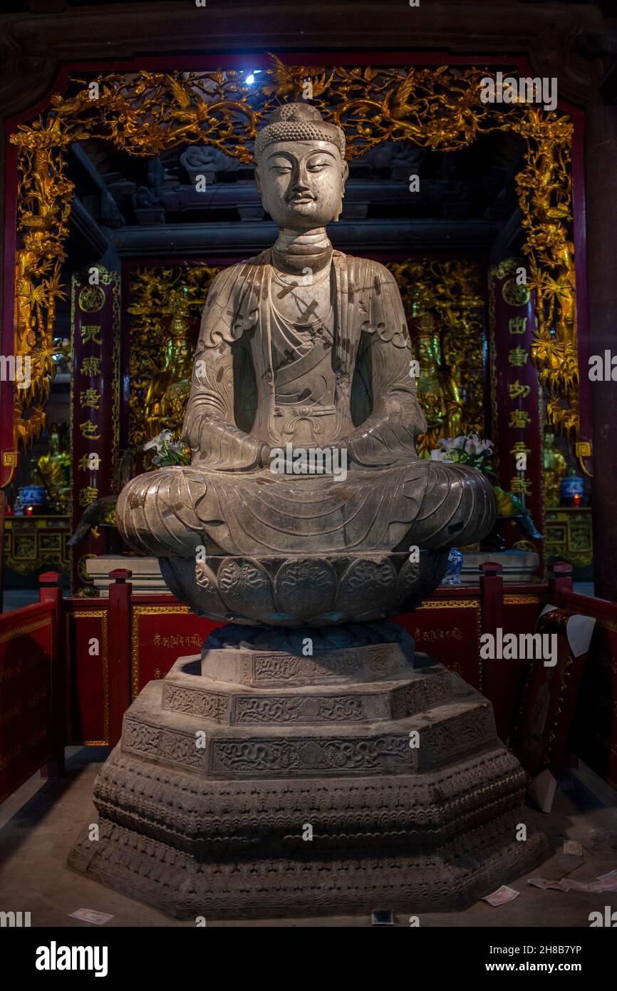 The Amitabha statue of Phat Tich Pagoda is a stone sculpture from the Ly Dynasty Stock Photo