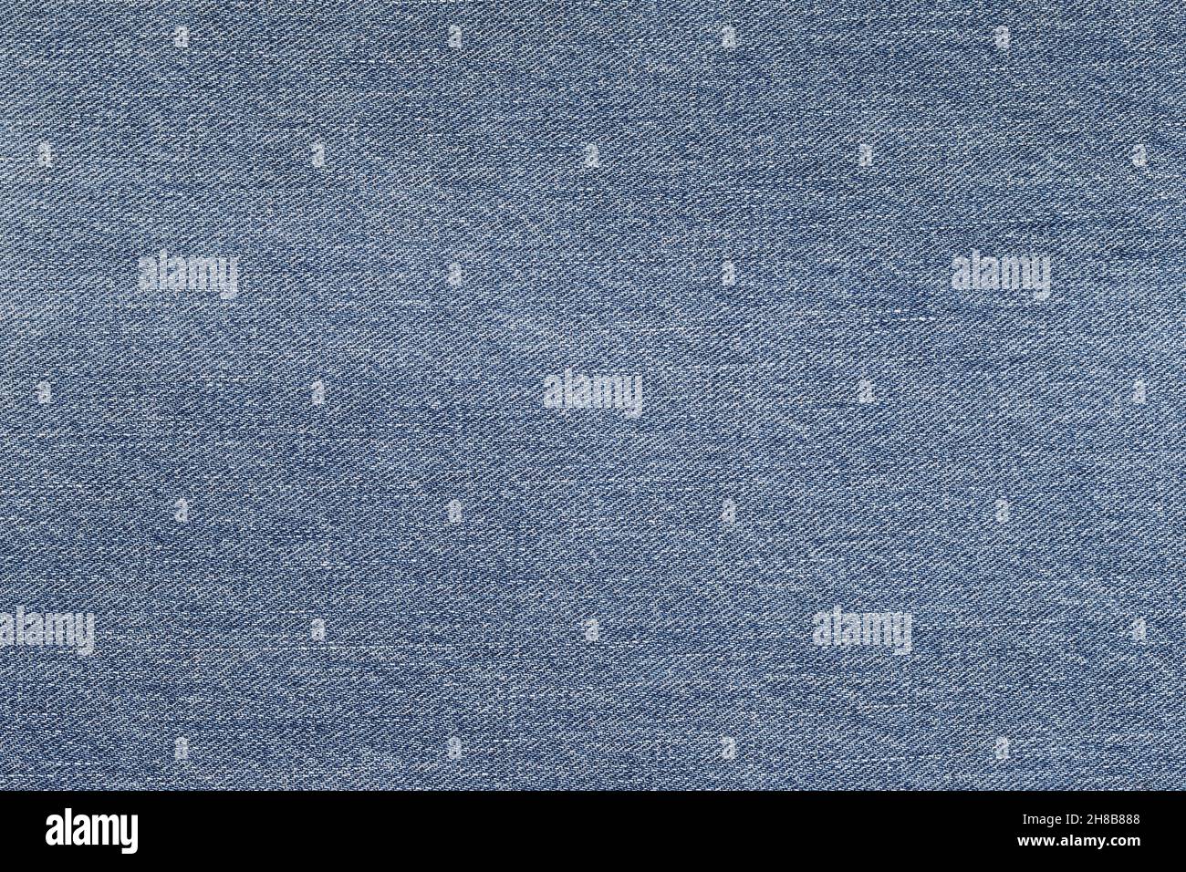 Denim background in blue fabric with faded. Blue discolored jeans close ...