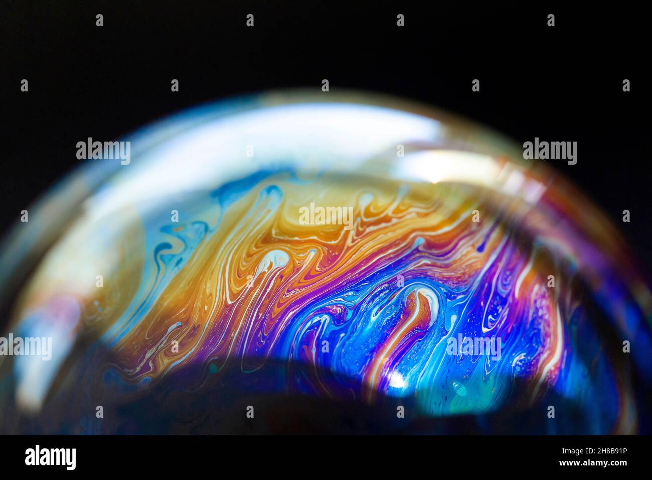 Abstract pattern, multicolored chaotic texture inside of the soap bubble, closeup Stock Photo