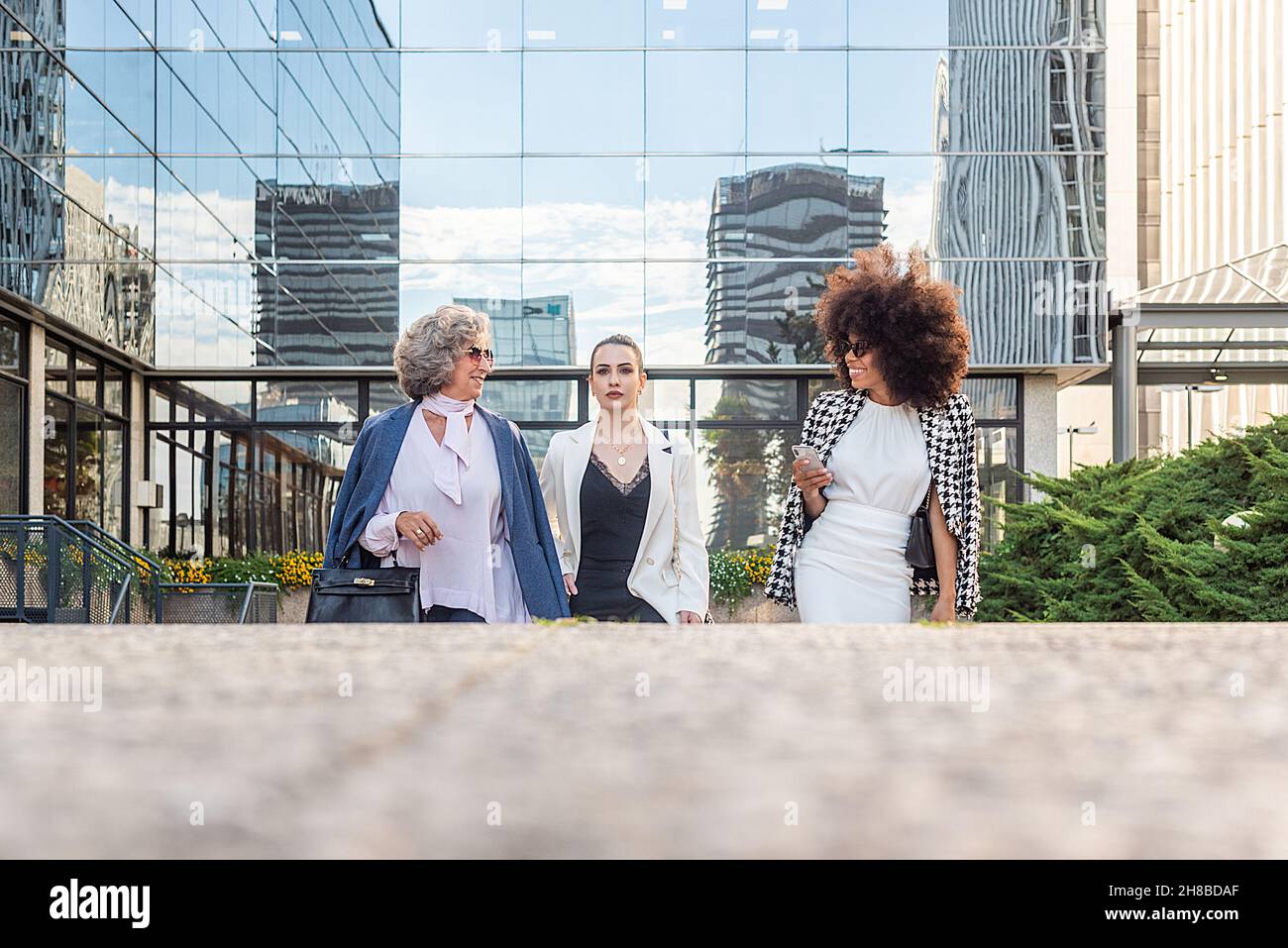 three business women leaving work talking to each other Stock Photo