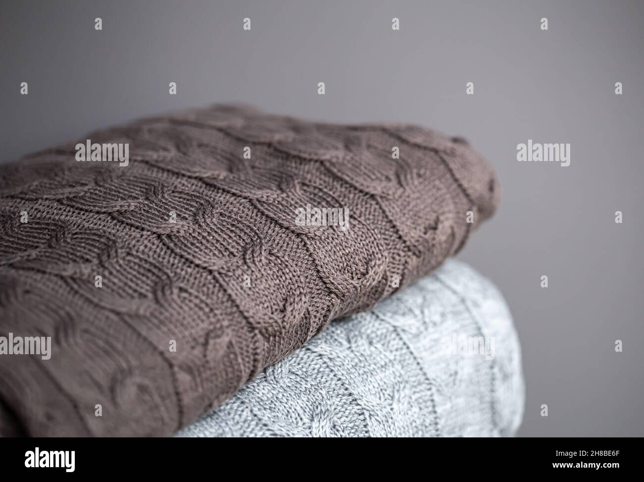 Close-up of textured knitted blankets in a stack. Stock Photo
