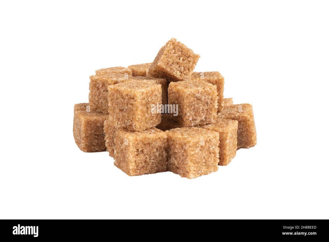 Brown unrefined cane sugar cubes isolated on white background. Macro shot heap refined sugar cubes isolated. Stock Photo