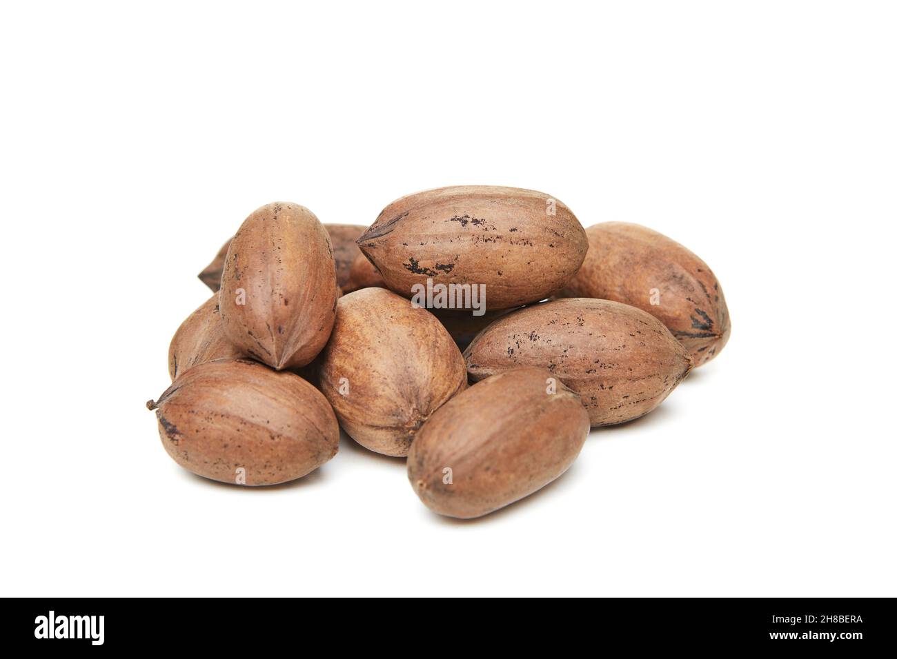 Pecan nuts heaped isolated on white background Stock Photo