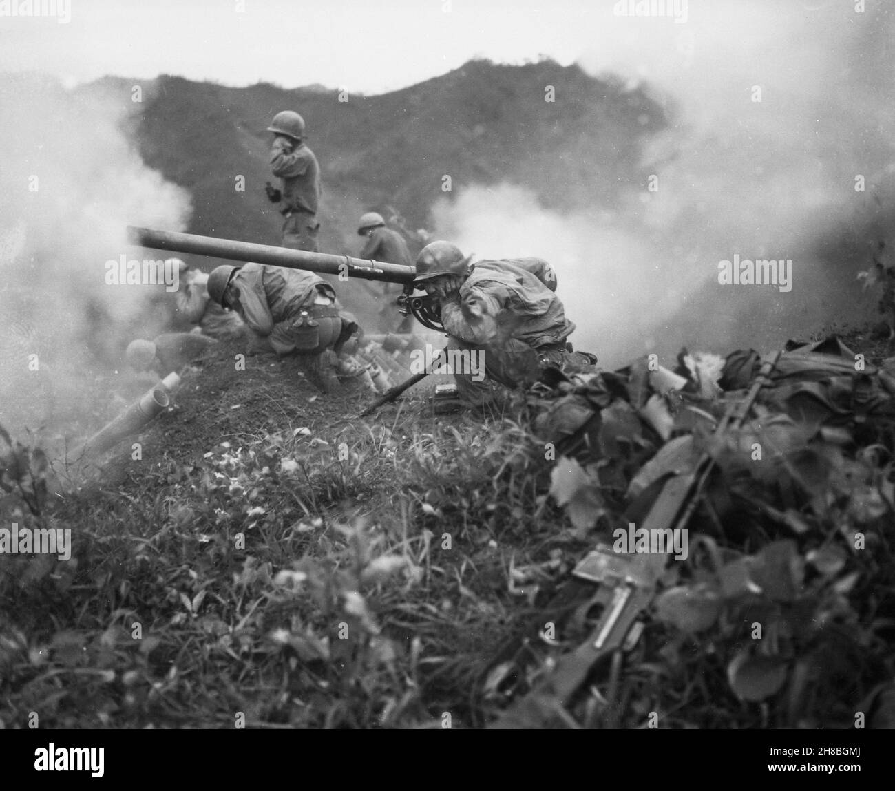 OETLOOK-TONG, KOREA - 09 June 1951 - US Army Private First Class Roman Prauty, a gunner with 31st Regimental Combat Team (crouching foreground), with Stock Photo