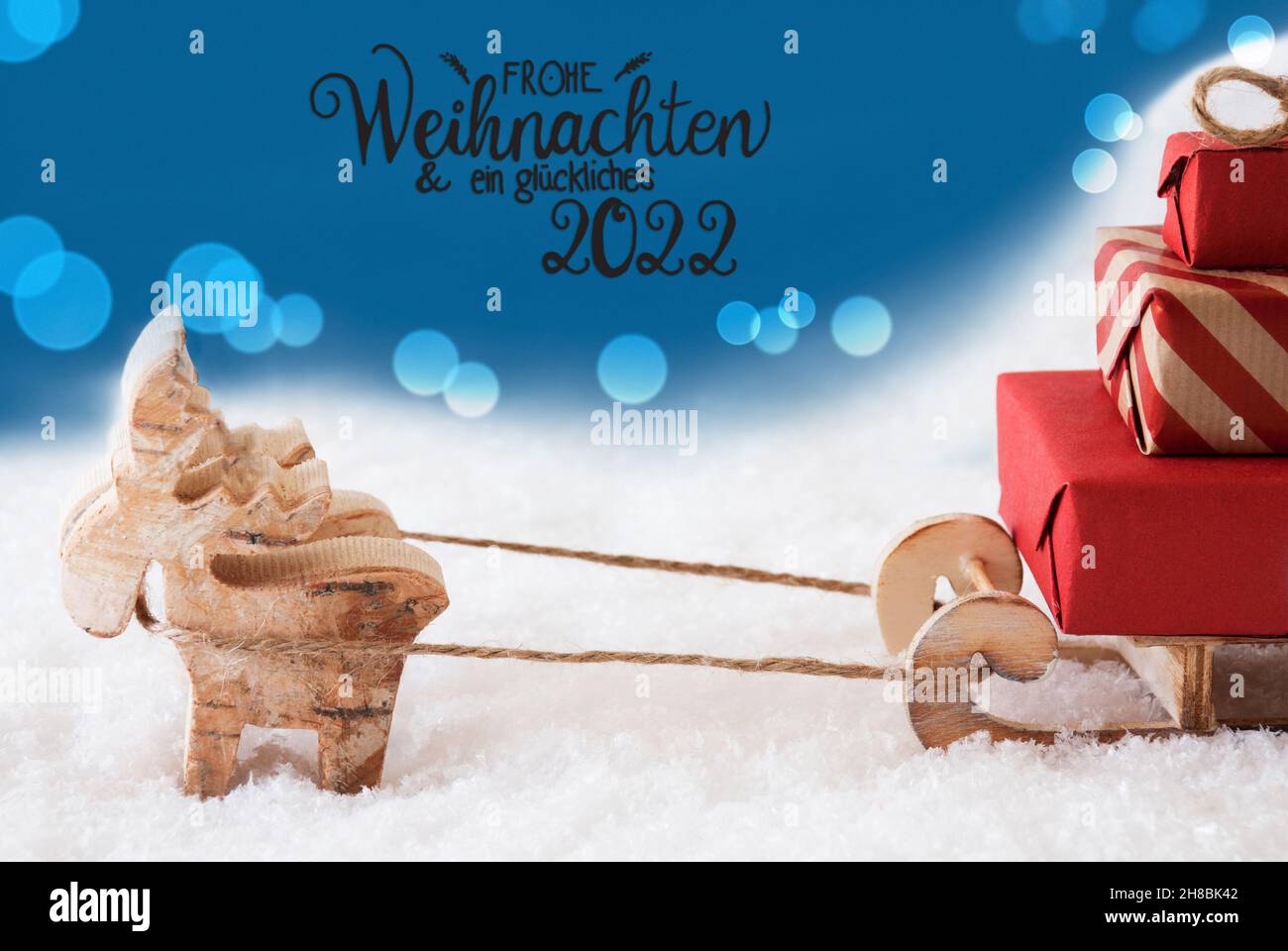 Reindeer, Sled, Snow, Blue Background, Glueckliches 2022 Mean Happy 2022 Stock Photo