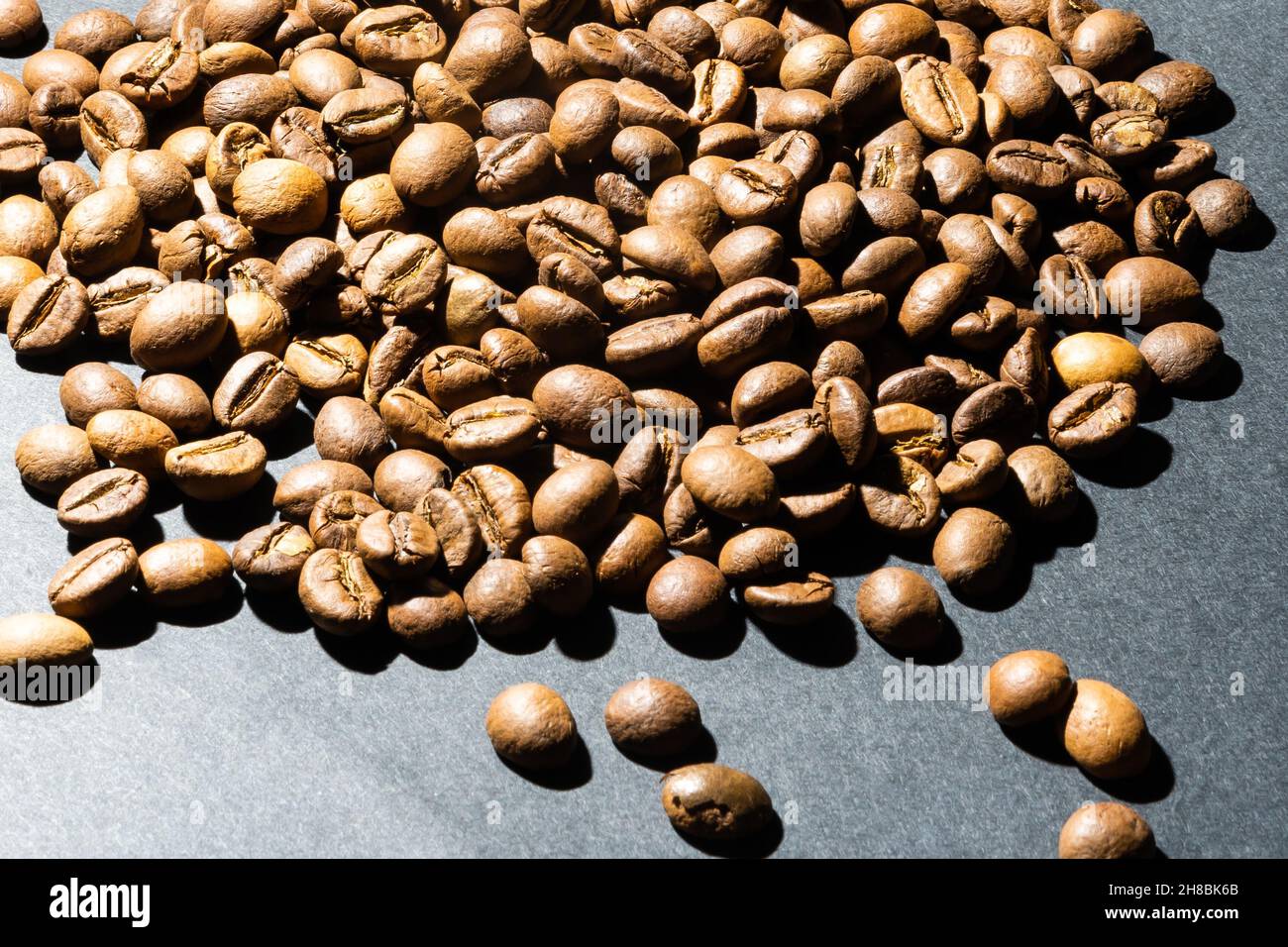 Pile coffee beans isolated on black background and texture, top view ...