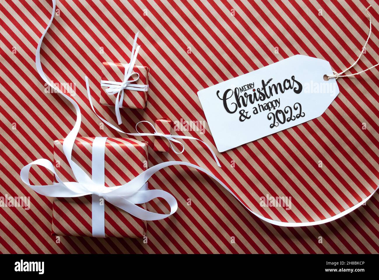 Three Gifts, Wrapping Paper, Label Merry Christmas And Happy 2022 Stock Photo