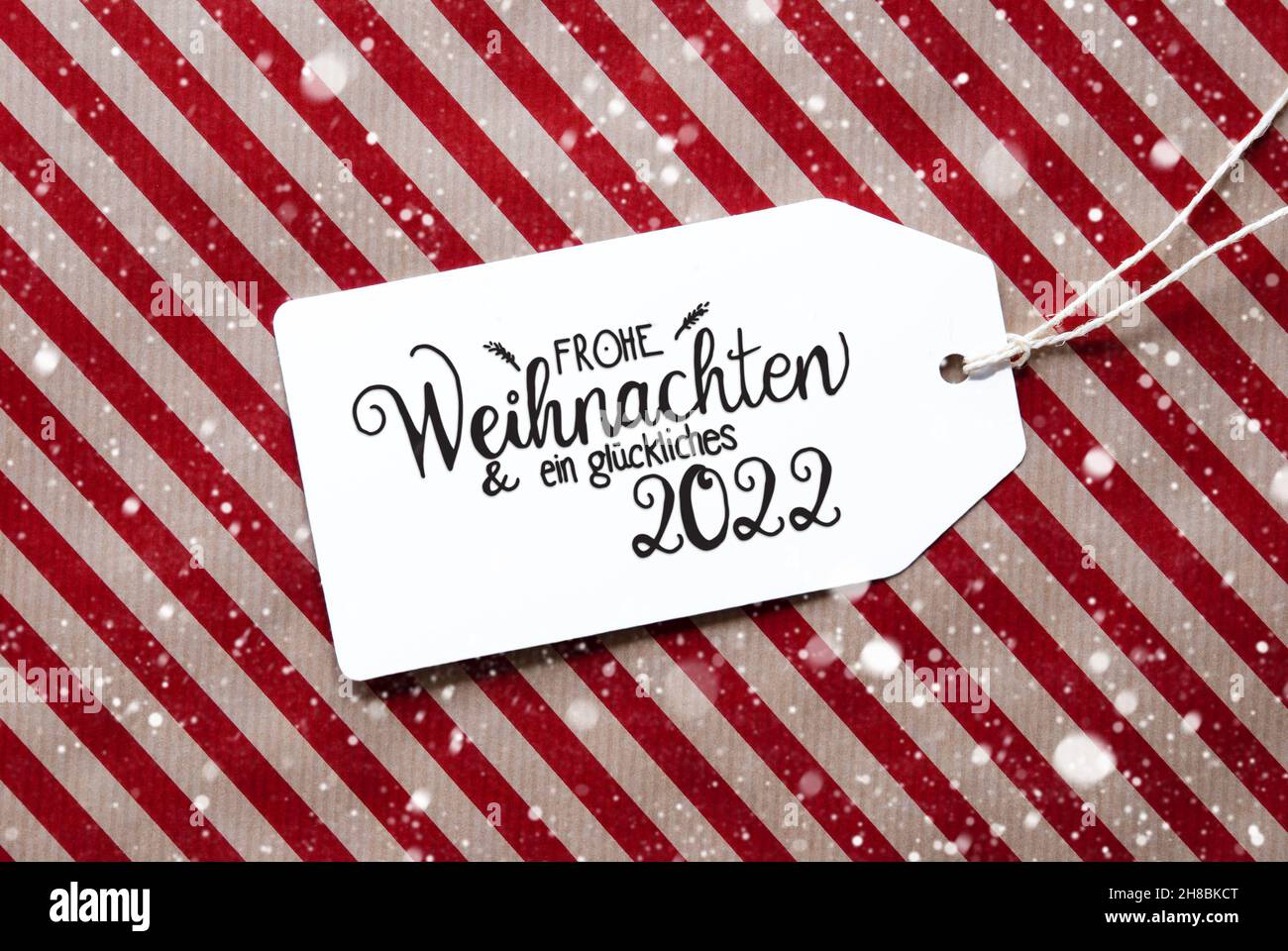 Red Wrapping Paper, Label, Glueckliches 2022 Means Happy 2022, Snowflakes Stock Photo