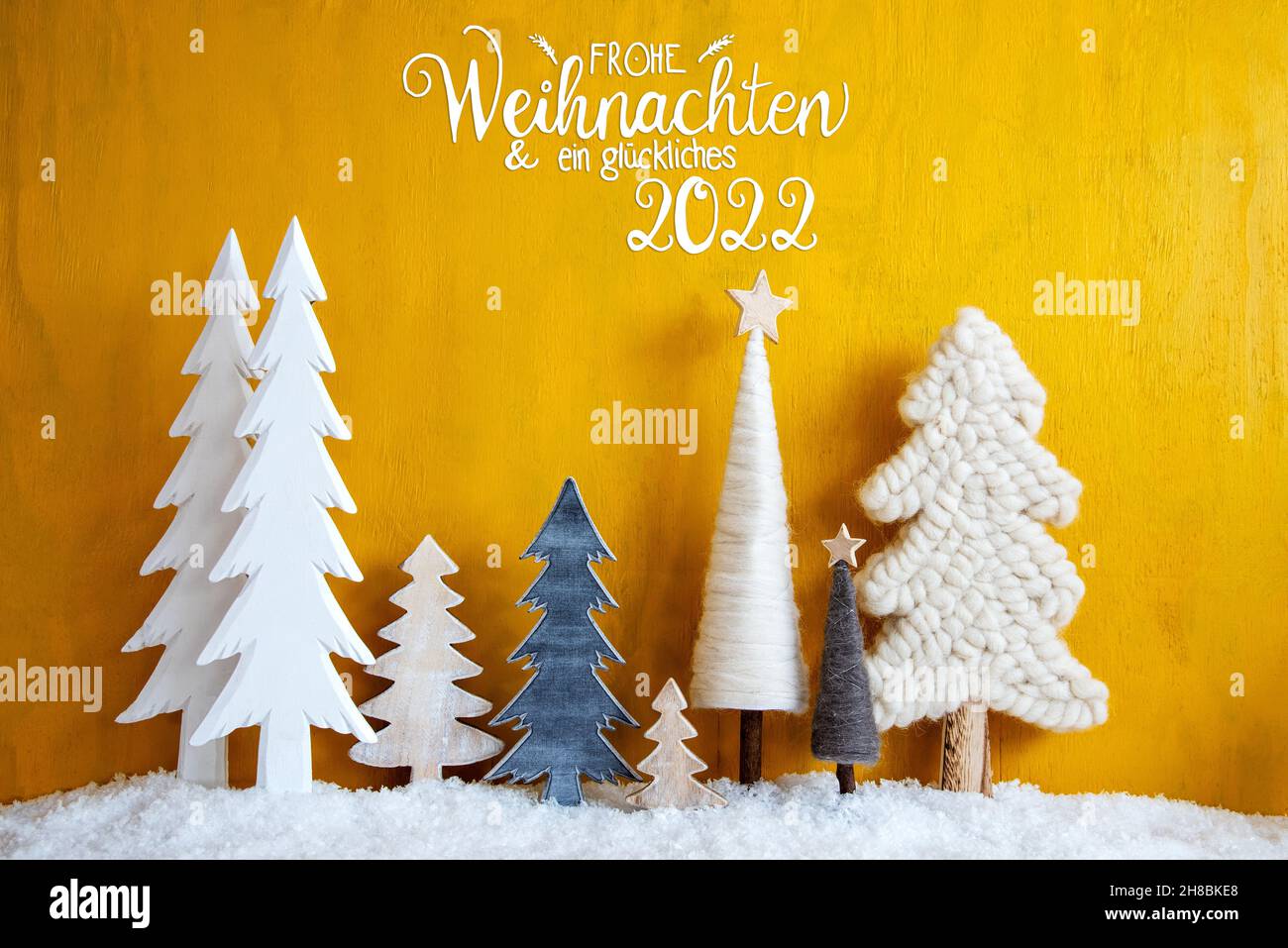 Christmas Trees, Snow, Yellow Background, Glueckliches 2022 Means Happy New Year Stock Photo
