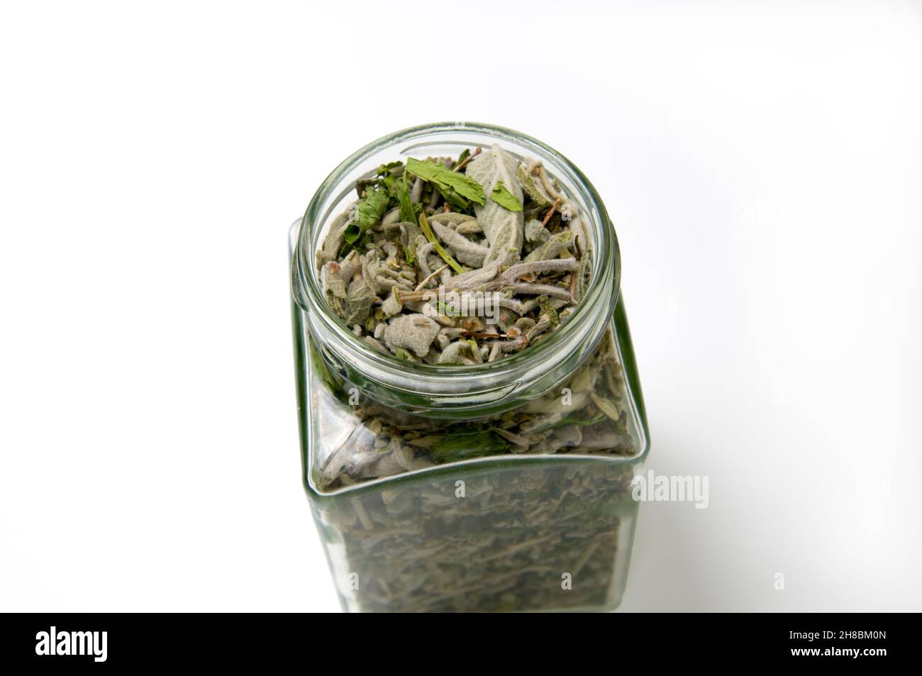 A jar of Herbal Tea mixture dried leaves and spices used for preparing ...