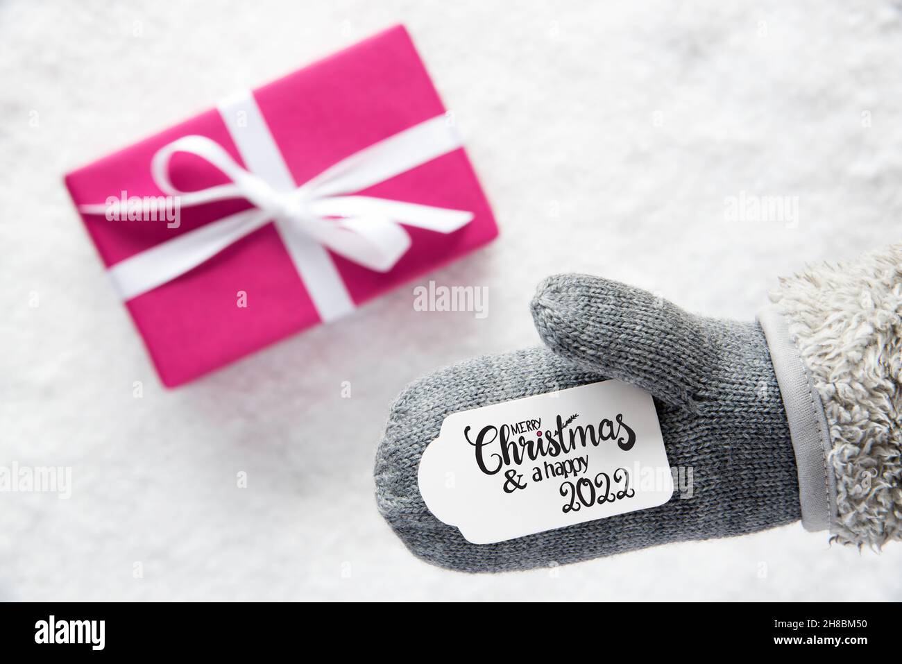 Gray Glove, Pink Gift, Label, Snow, Merry Christmas And A Happy 2022 Stock Photo
