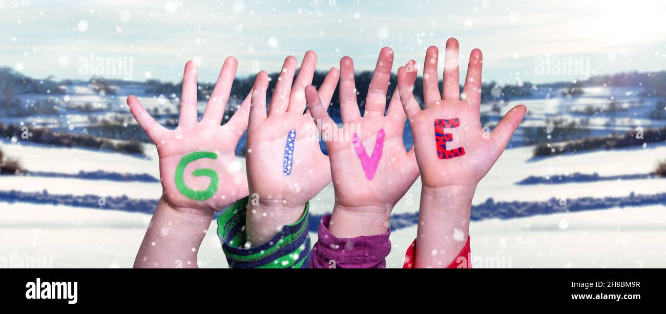 Children Hands Building Word Give, Snowy Winter Background Stock Photo