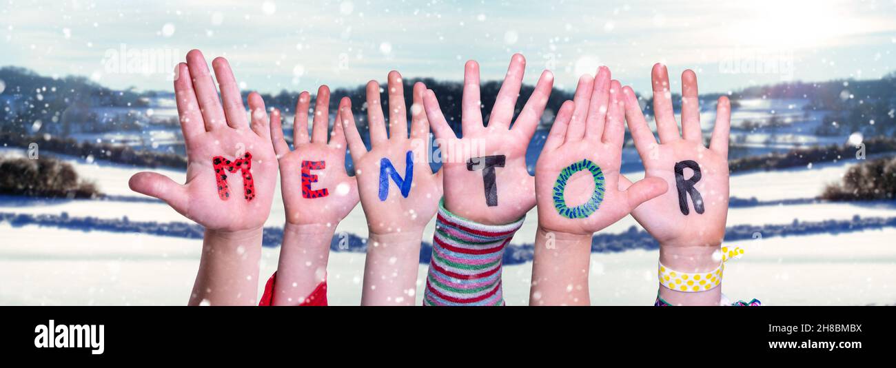 Children Hands Building Word Mentor, Snowy Winter Background Stock Photo