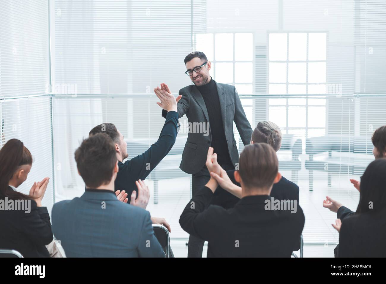 business colleagues giving each other a high five Stock Photo