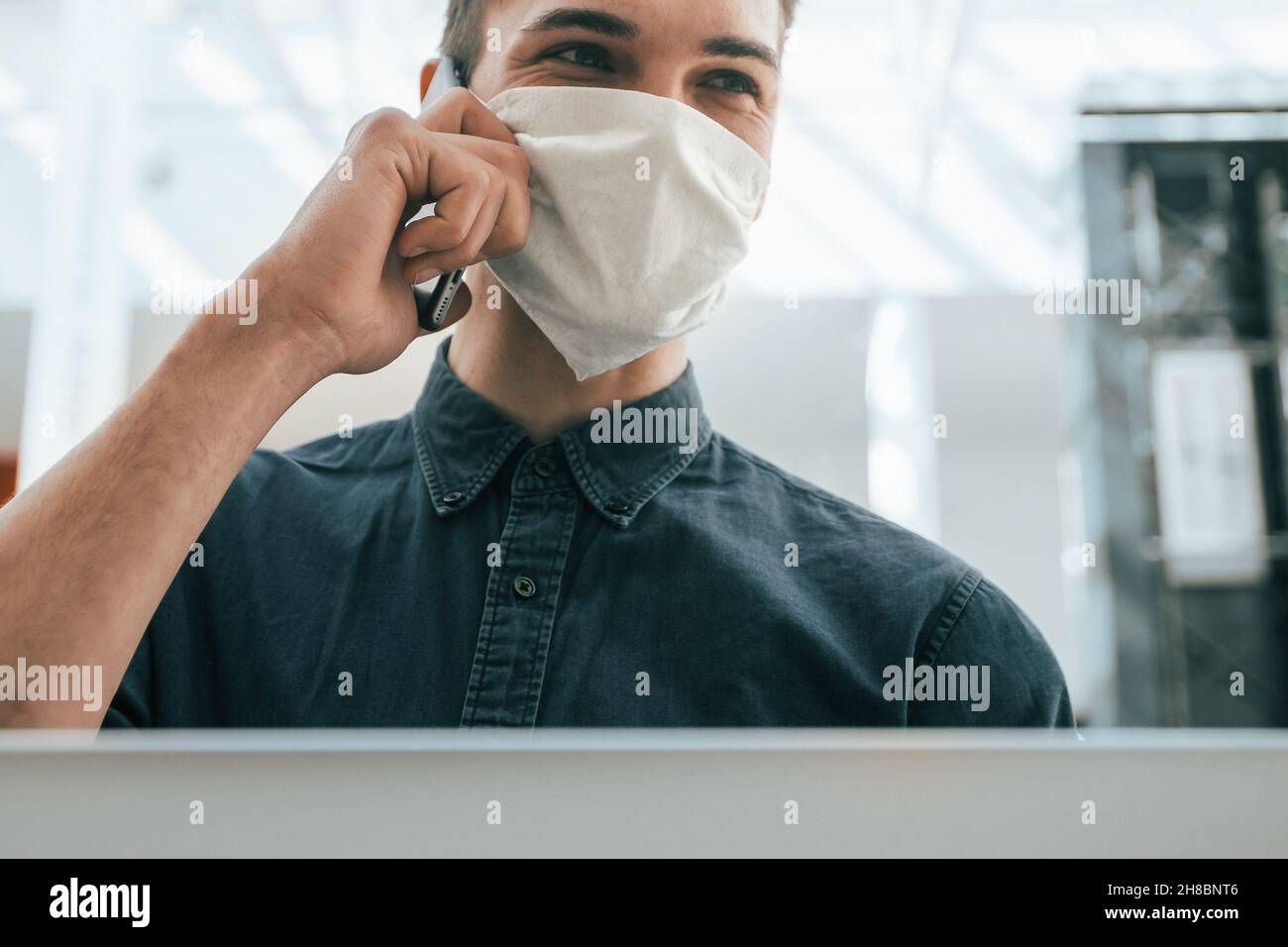 close up. a young man in a protective mask using a laptop Stock Photo ...
