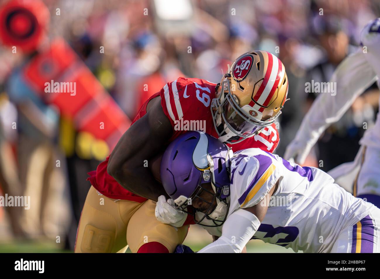 San Francisco 49ers wide receiver Deebo Samuel (19) runs in for the touchdown while Minnesota Vikings free safety Xavier Woods (23) attempts to tackle Stock Photo