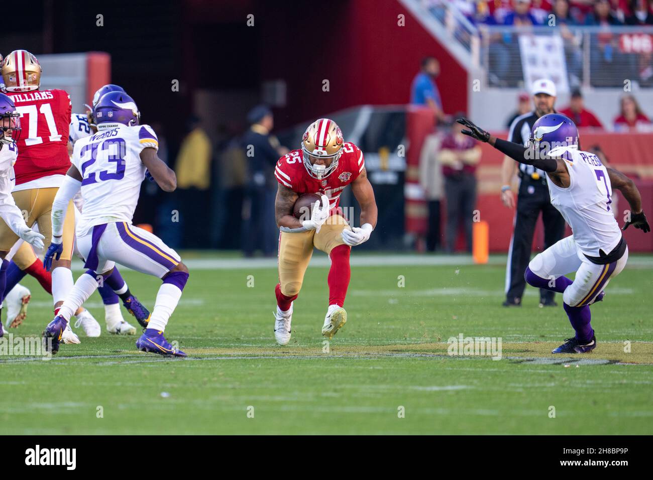 San Francisco 49ers running back Eli Mitchell (25) runs with the football during the first quarter against Minnesota Vikings free safety Xavier Woods Stock Photo