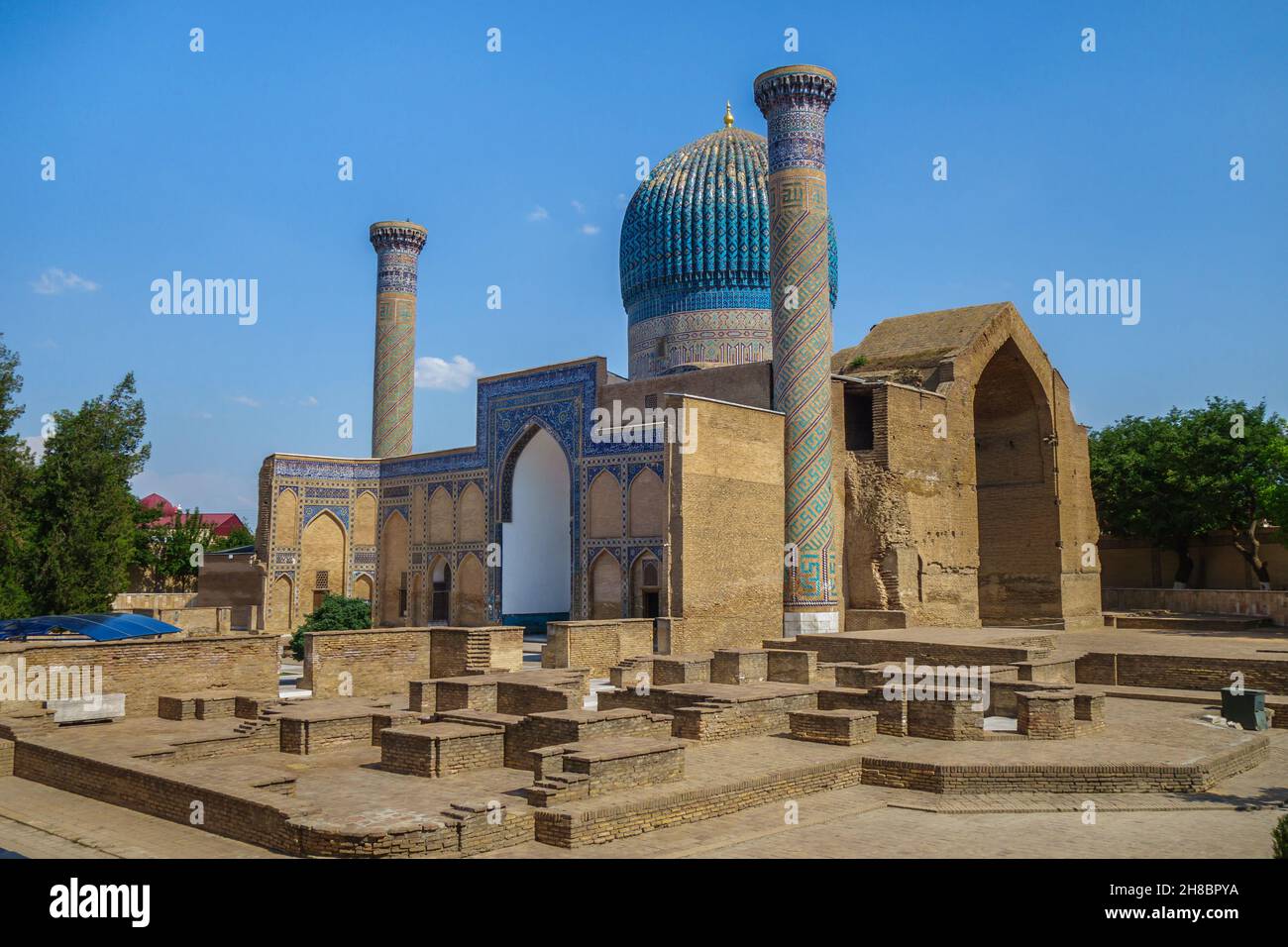 Panorama of Gur-e-Amir, mausoleum of Timur (Tamerlane), Samarkand, Uzbekistan. Remains of ancient buildings in the foreground. Complex built in 1403. Stock Photo