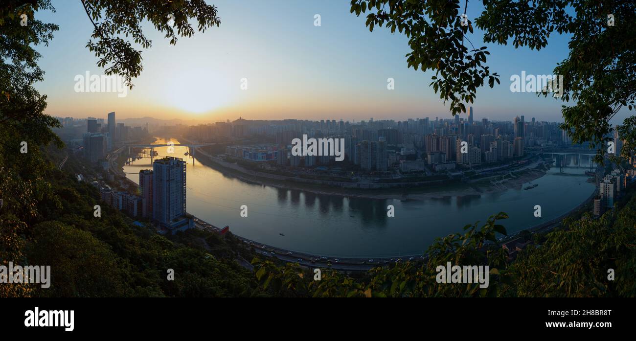 The river is called the Jialing River and this is Chongqing, China. Towards the end of the evening, the city view on the bank of the river Stock Photo